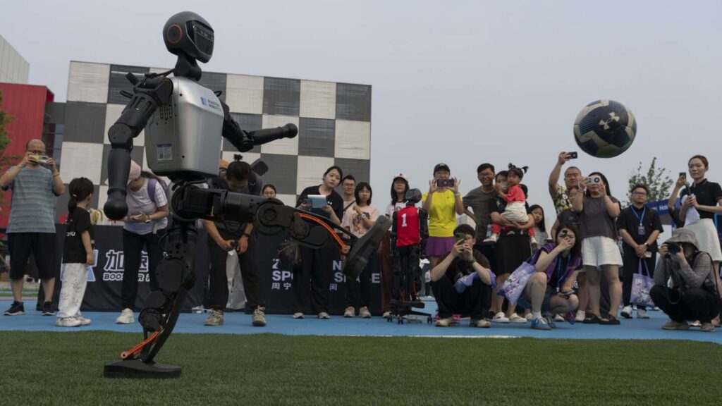 Photos show how humanoid robots captivate fans in China by playing a soccer match
